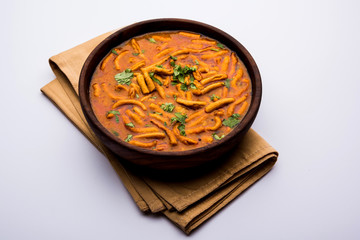 Dhaba style Sev bhaji/sabzi/curry made in tomato curry with gathiya shev, served in a bowl or karahi, selective focus