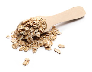 Spelta flakes, rye grain cereal for breakfast in wooden spoon isolated on white background
