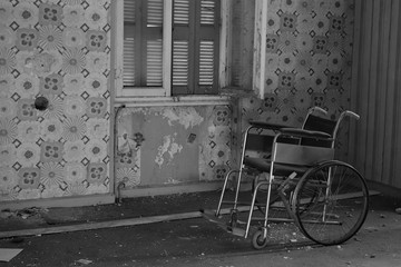antique wheelchair in abandoned house