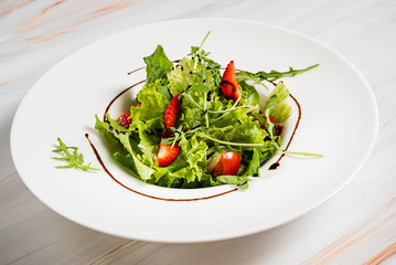 healthy salad with strawberriesa and arugula