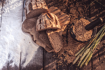 bread flour and corn on a old table with cornfield in the background