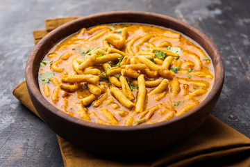 Dhaba style Sev bhaji/sabzi/curry made in tomato curry with gathiya shev, served in a bowl or karahi, selective focus