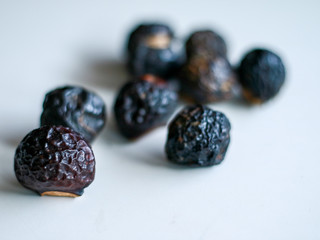 Sapindus rarak (lerak) on white background. In Indonesia lerak is used to wash batik.