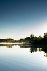 Misty morning on a lake with clear skies