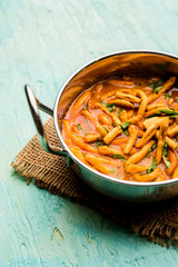Dhaba style Sev bhaji/sabzi/curry made in tomato curry with gathiya shev, served in a bowl or karahi, selective focus