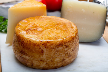 Variety of Italian pecorino cheeses, yellow aged, with black peppers from Nebrodi, white Il Palio and black molarotto, close up