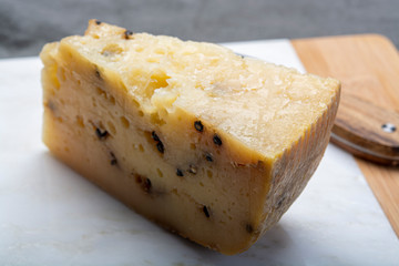 Italian aged pecorino cheese with black peppers made in region Nebrodi, Sicily, Italy