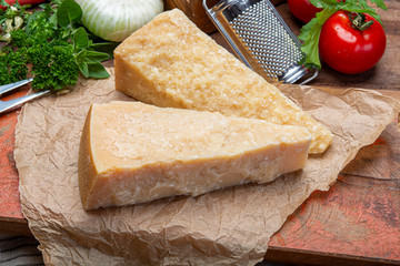 Italian original aged Parmesan cheese in two pieces close up
