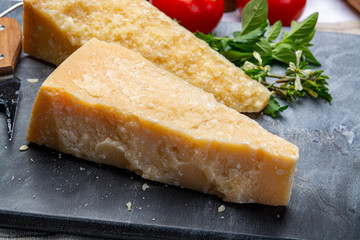 Italian original aged Parmesan cheese in two pieces close up
