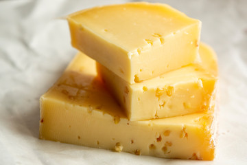 Piece of cow cheese with fenugreek seeds made in Belgian abbey by monks.