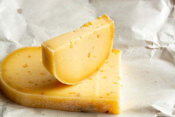 Piece of cow cheese with fenugreek seeds made in Belgian abbey by monks.