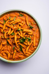 Dhaba style Sev bhaji/sabzi/curry made in tomato curry with gathiya shev, served in a bowl or karahi, selective focus