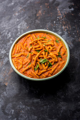 Dhaba style Sev bhaji/sabzi/curry made in tomato curry with gathiya shev, served in a bowl or karahi, selective focus