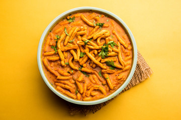 Dhaba style Sev bhaji/sabzi/curry made in tomato curry with gathiya shev, served in a bowl or karahi, selective focus