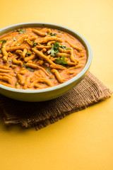 Dhaba style Sev bhaji/sabzi/curry made in tomato curry with gathiya shev, served in a bowl or karahi, selective focus