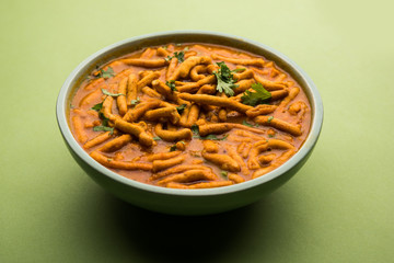 Dhaba style Sev bhaji/sabzi/curry made in tomato curry with gathiya shev, served in a bowl or karahi, selective focus