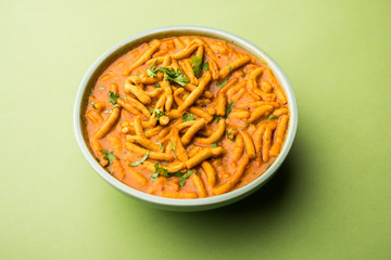 Dhaba style Sev bhaji/sabzi/curry made in tomato curry with gathiya shev, served in a bowl or karahi, selective focus