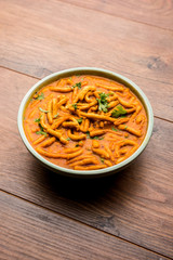 Dhaba style Sev bhaji/sabzi/curry made in tomato curry with gathiya shev, served in a bowl or karahi, selective focus