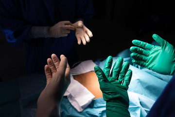 Surgeons wearing surgical gloves in operating room