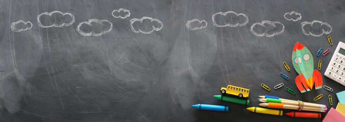 education. Back to school concept. rocket cut from paper and painted over blackboard background....