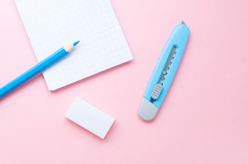 Notepad and pencil on color background