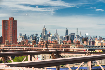 New York City, Brooklyn Bridge and Lower Manhattan Skyscrapers. Cloudy Blue Sky Background