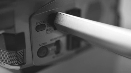 Manual button dial of a mini dv camcorder camera, close up macro shot