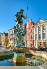 Neptune fountain and colorful facades of old buildings on the Maket square in Poznan © tilialucida