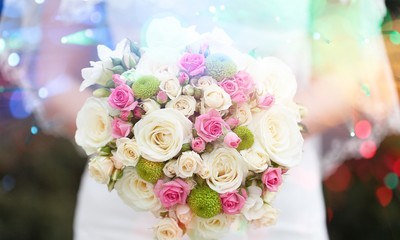 Bride with beautiful wedding bouquet on background