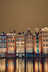 Foto op Canvas Brick houses and canal in amsterdam at night © badahos