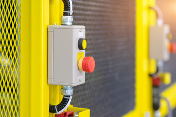 View of emergency switch on safety fence of automation machine