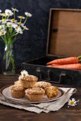 Healthy carrot cake muffins on the plate being sprinkled with powdered sugar. Vegan food, for menu