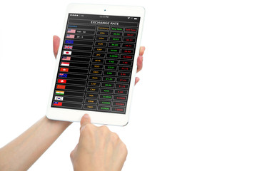 Hands holding tablet with currency exchange rates