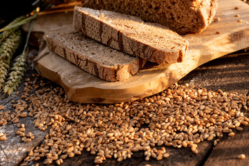 bread flour and corn on a old table with cornfield in the background