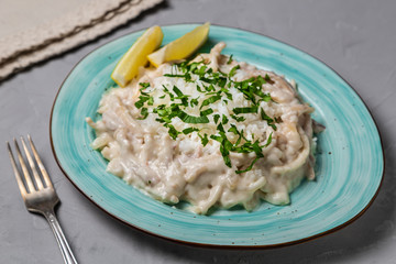 Squid in sour cream sauce. Greek national dish