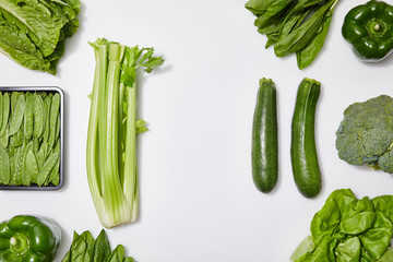 top view of green organic vegetables on white background