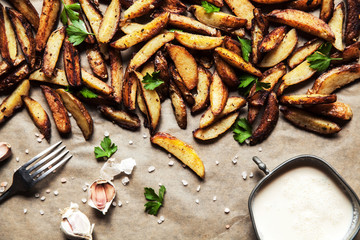 Delicious potatoes with rosemary on parchment, closeup