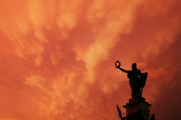 Stormy clouds over the monument and buildings of the Reconciliation Park of Arad, Romania, Europe