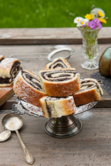 Poppy seed strudel. Homemade cake. Rustic wooden backgroud. Top view. Picnic in nature.