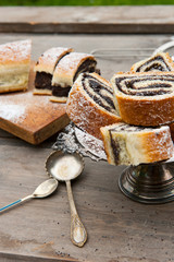 Poppy seed strudel. Homemade cake. Rustic wooden backgroud. Top view. Picnic in nature.