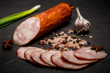 large chunk of smoked ham sausage with garlic and green onion