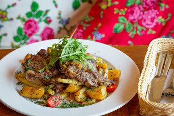 Roasted sheep meat with potatoes and beans