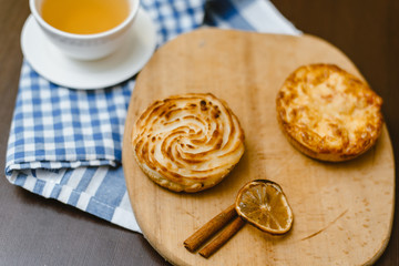 Tea with cottage cheese buns on a wooden background. Delicious breakfast.