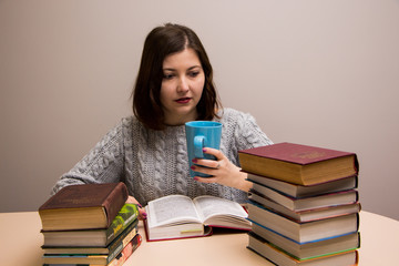 Student girl with stack of books 