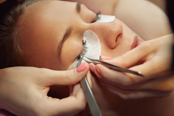 beautician making artificial lashes. eyelash extension procedure. - 276176643