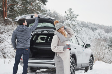 Couple have arrived to their destination of beautiful winter forest