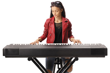 Young female playing a keyboard - Powered by Adobe