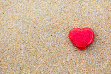 Fototapeta premium Chocolate color Lovely red heart on the beach. Background is a natural in real place, creative Valentine's Day Concept, tropical style background made in Phuket, Thailand.