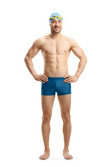 Fototapeta premium Man in swimming shorts, googles and a cap posing