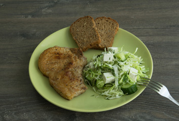Baked pork, cabbage salad, cucumbers, brine cheese and grain bread
